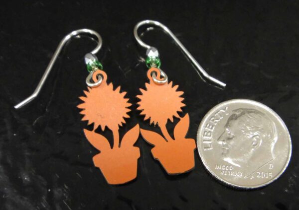 backside of sunflower earrings with dime for scale
