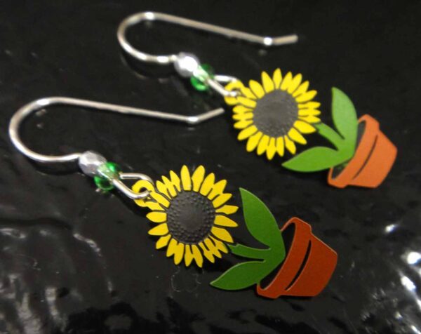 sunflower earrings on black background