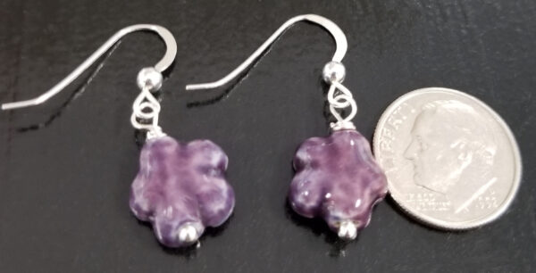 dark purple daisy earrings with dime for scale