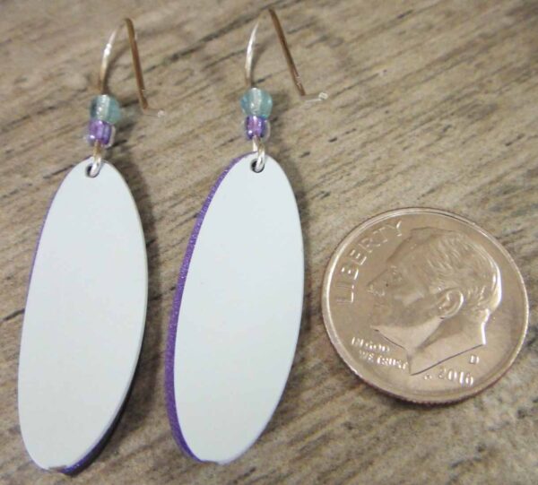 back of iris earrings with dime for scale