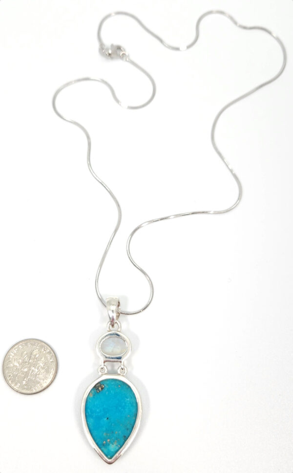 Backside of rainbow moonstone and turquoise necklace with dime for size comparison