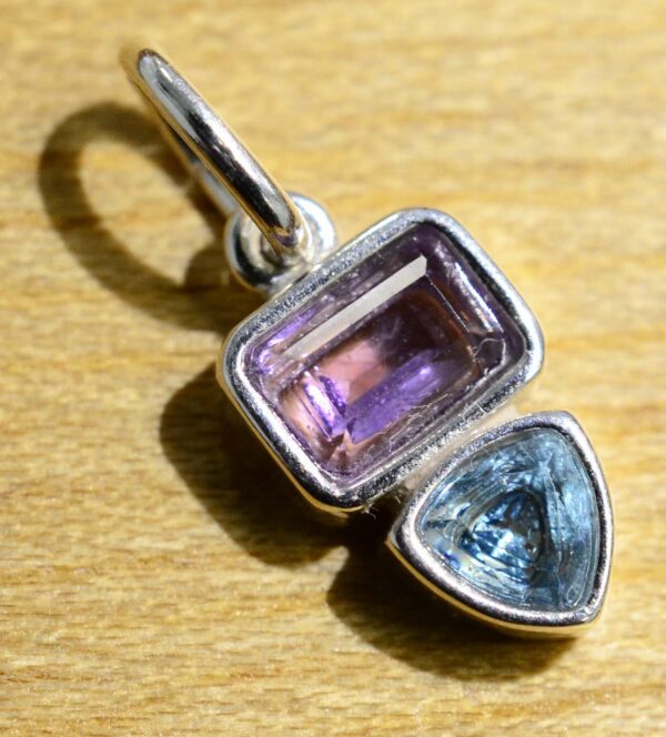 This sterling silver blue topaz and amethyst pendant is handmade by Sonoma Art Works.