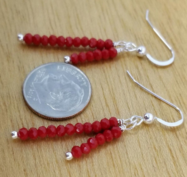 red art glass earrings with dime for scale
