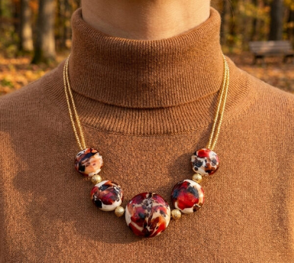 close-up of red Murano glass necklace on woman