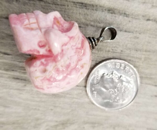 skull pendant with dime for scale