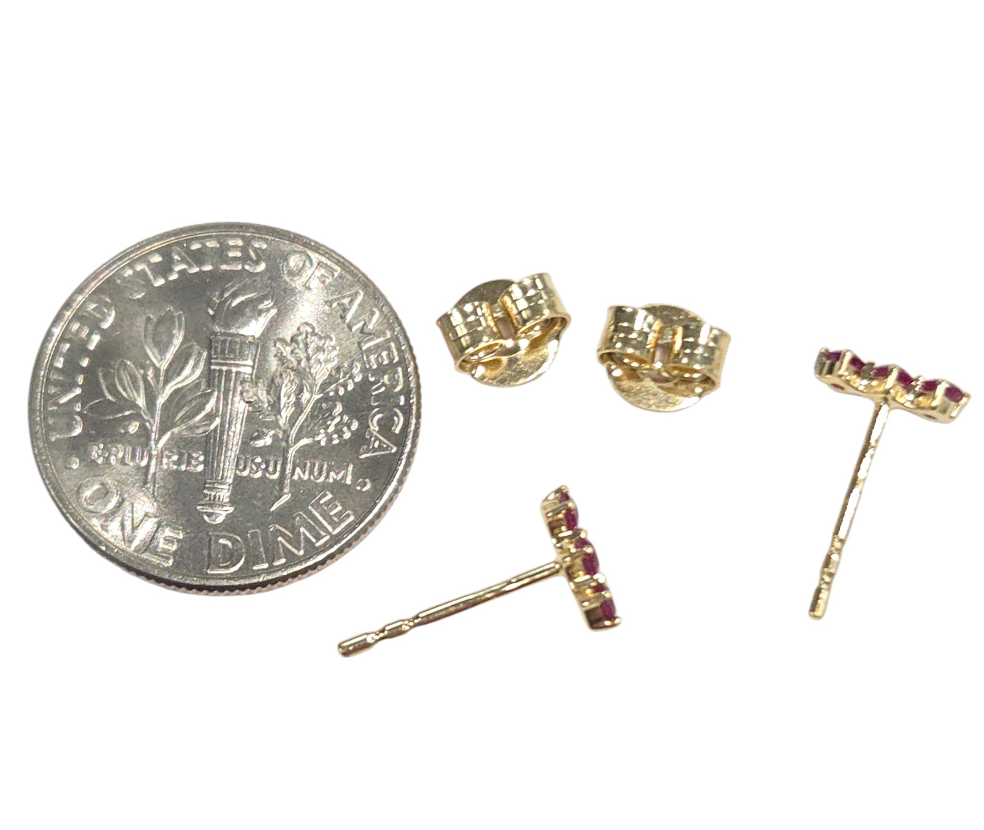 backside of ruby earrings with dime for size comparison
