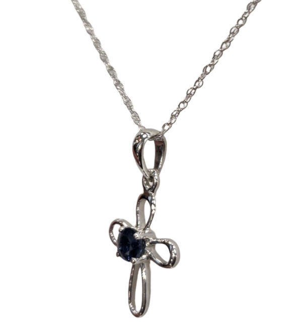 side view of dainty sapphire and white gold cross necklace