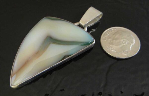 Handmade sardonyx and sterling silver pendant shown with dime (not included) for scale