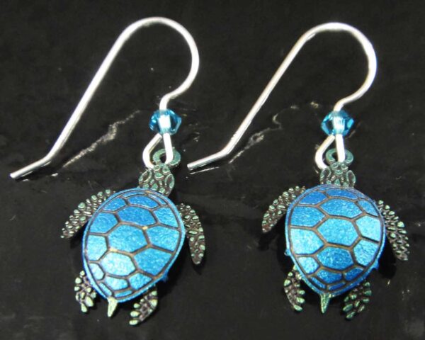 sea turtle earrings on black background