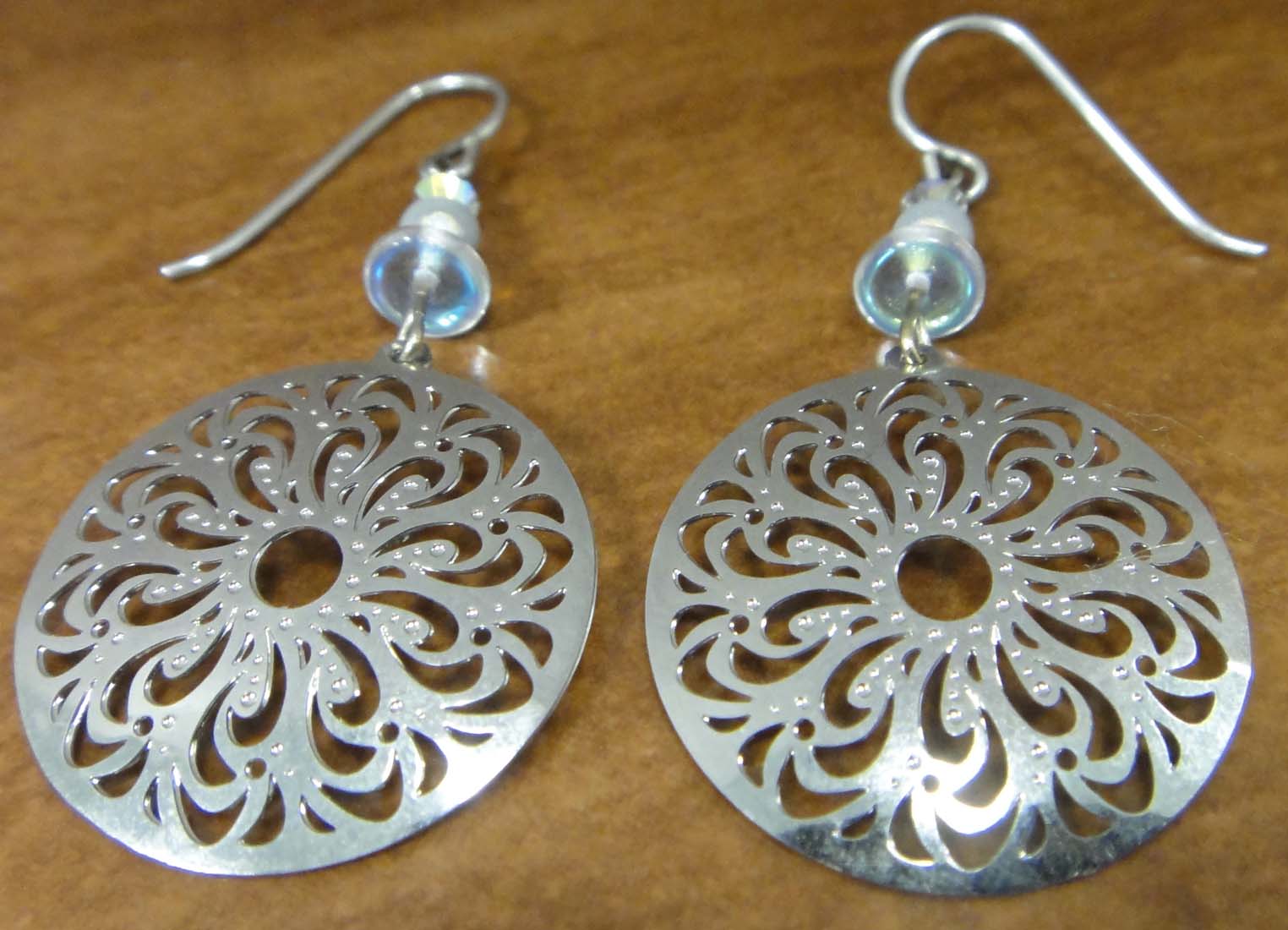 These silver-tone filigree circle dangle earrings are handmade by Adajio.