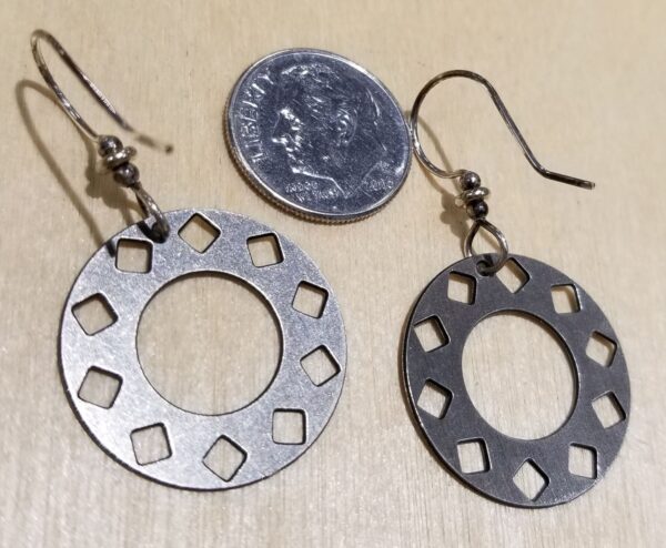 back of silver-tone circle earrings with dime for scale
