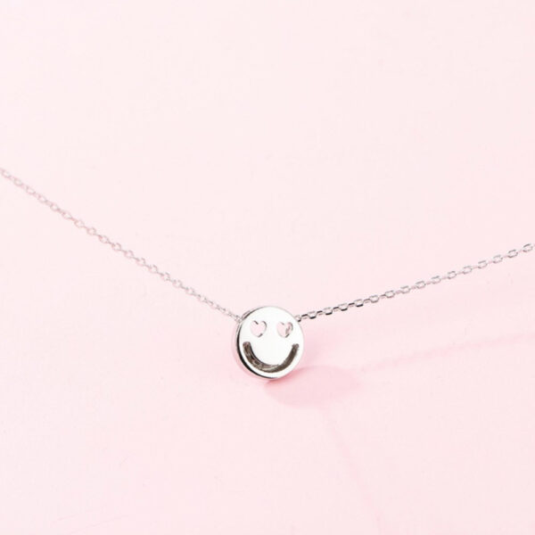 smiley face necklace with heart shaped eyes in sterling silver
