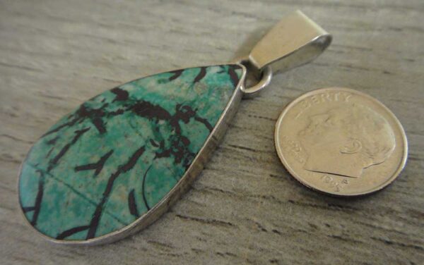 Handmade sonoran sunrise jasper and sterling silver pendant shown with dime (not included) for scale