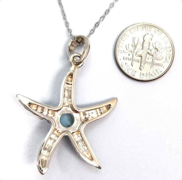 backside of starfish pendant with dime for size comparison