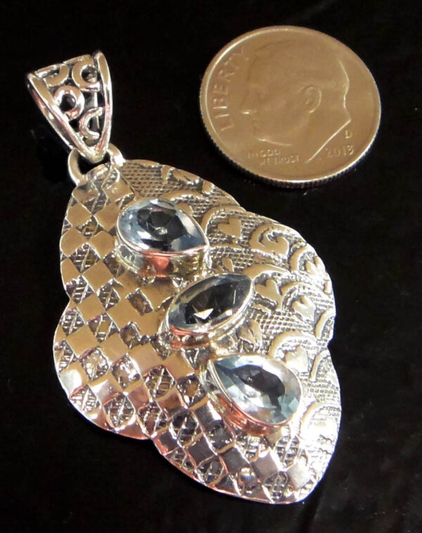 blue topaz sterling silver pendant with dime for scale