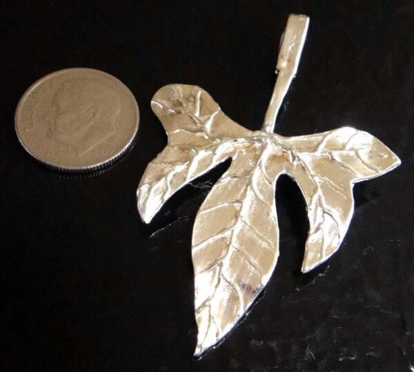 Stylized tropical leaf sterling silver pendant