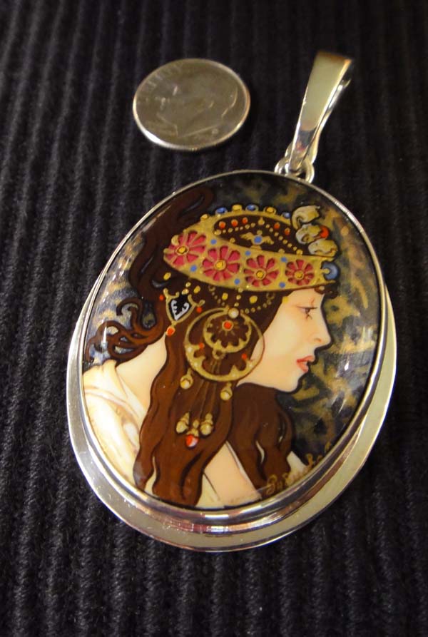 Alphonse Mucha's The Brunette hand painted onyx and sterling silver oval pendant with dime for size