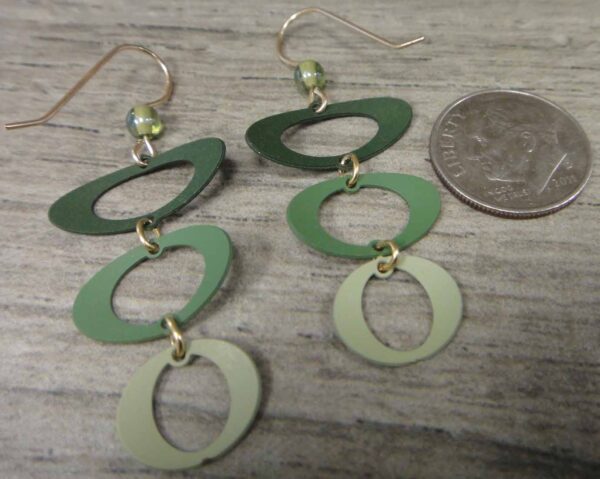 backside of green Adajio earrings with dime to help show scale