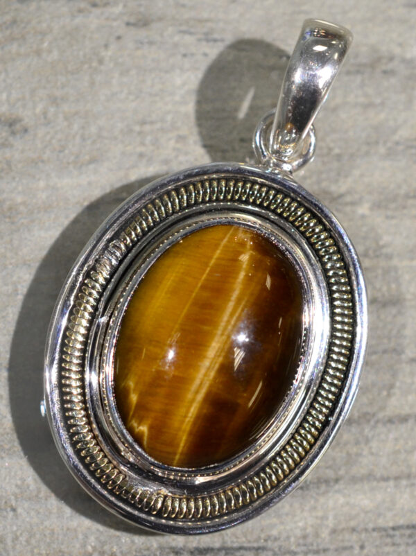 handmade oval tiger's eye pendant set in sterling silver with bronze accents