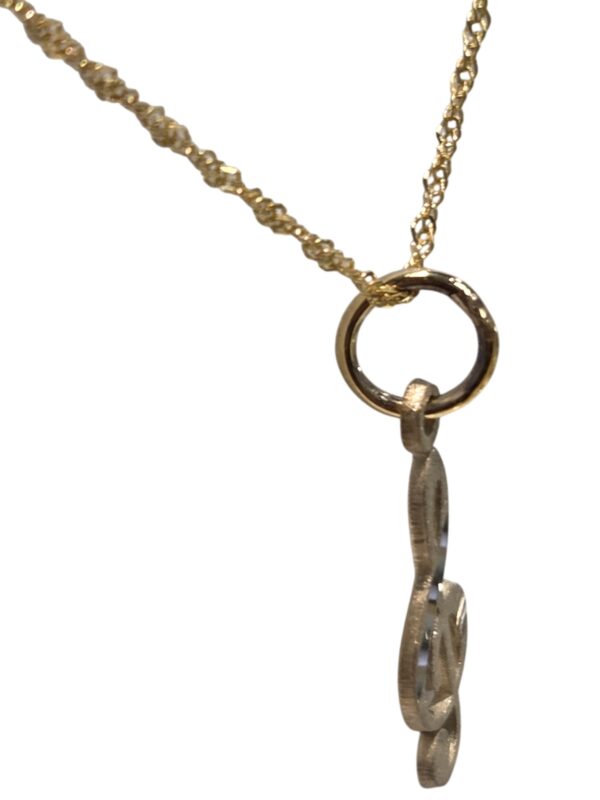 side view of treble clef necklace