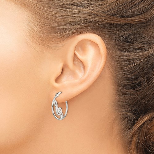 treble clef hoop earrings on ear