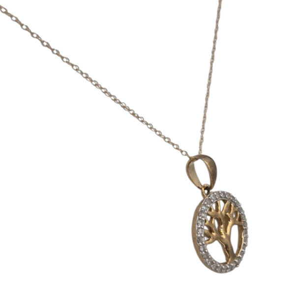 side view of diamond and gold tree of life necklace