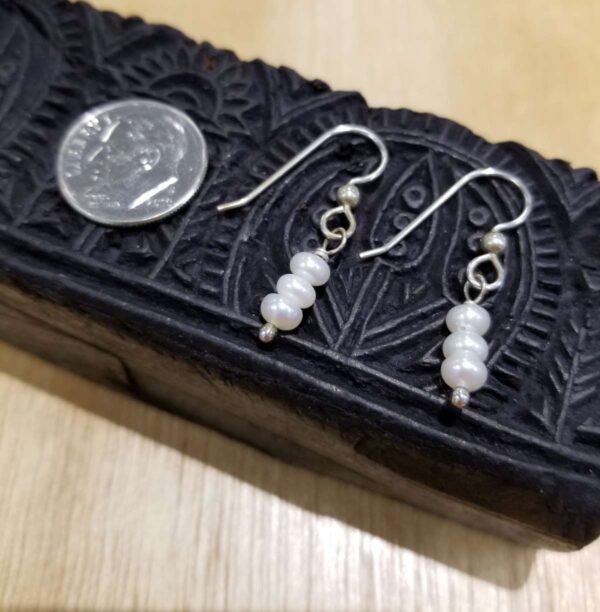 white fresh water pearl earrings with dime for scale