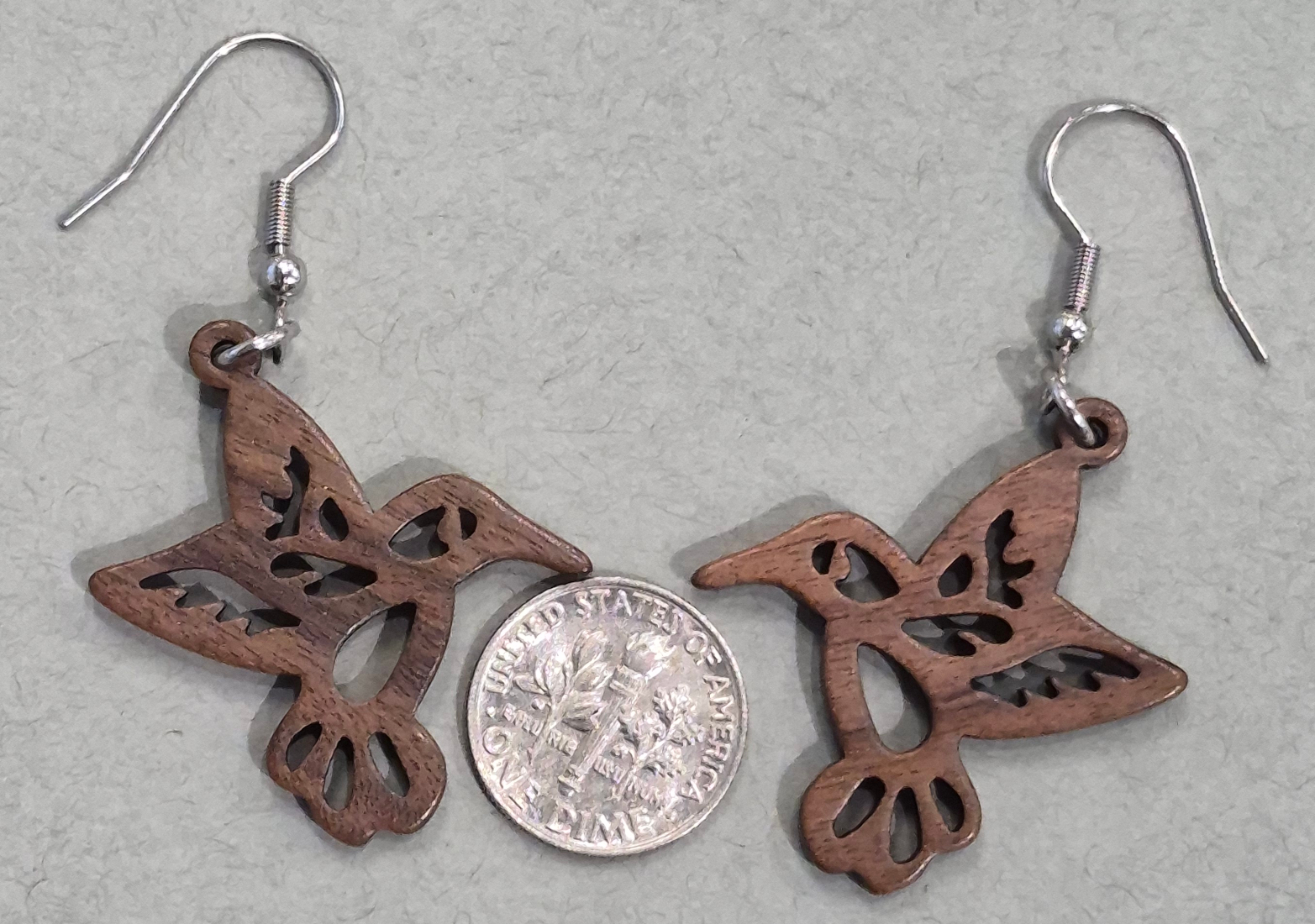 wood hummingbird earrings with dime for size comparison