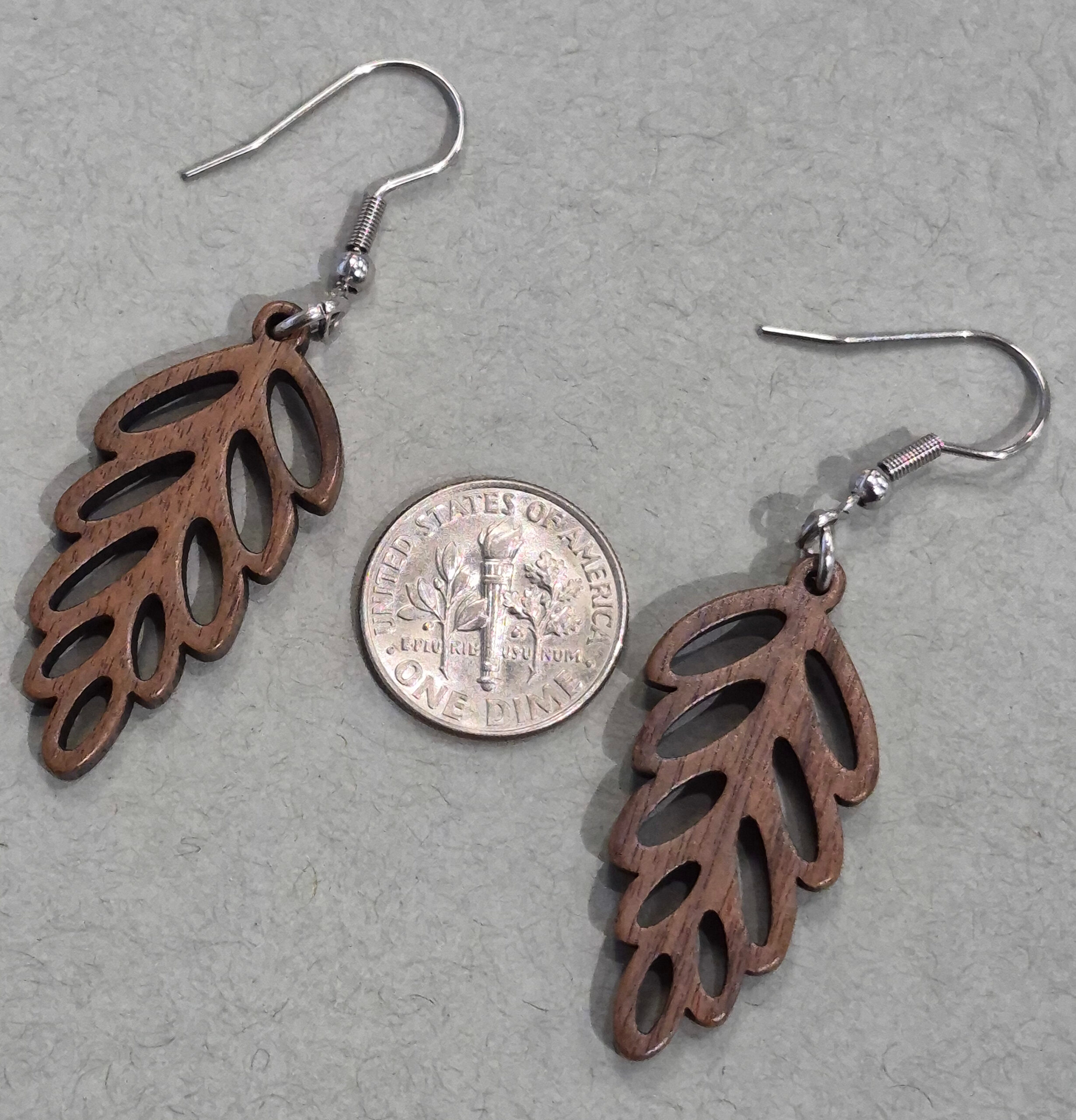 wood leaf earrings with dime for size comparison