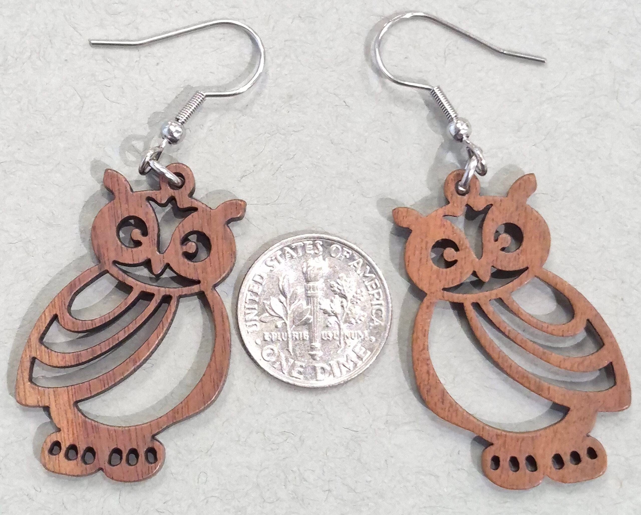 wood owl earrings with dime for size comparison