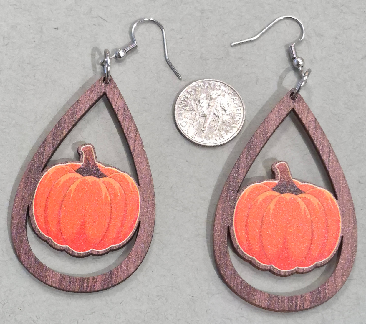 wooden drop pumpkin earrings with dime for size comparison
