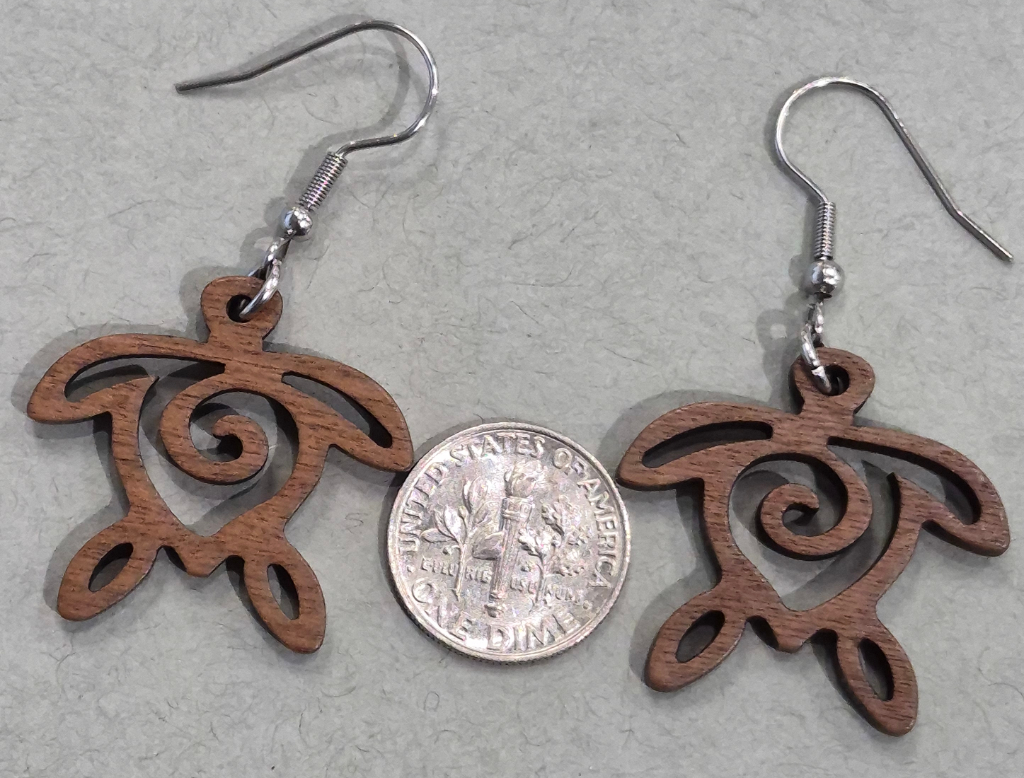 wood sea turtle earrings with dime for size comparison