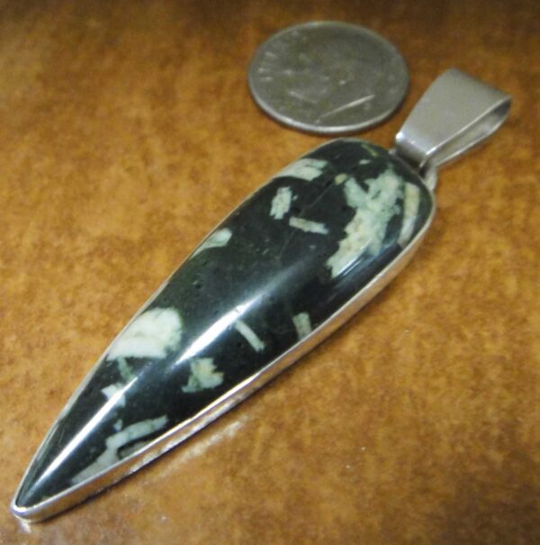 elongated point writing stone pendant with dime for size