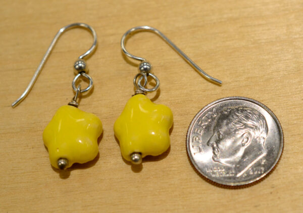 back of ceramic yellow flower earrings with dime