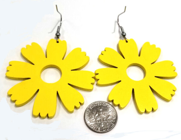 back of large yellow wooden flower earrings with dime to help gauge scale